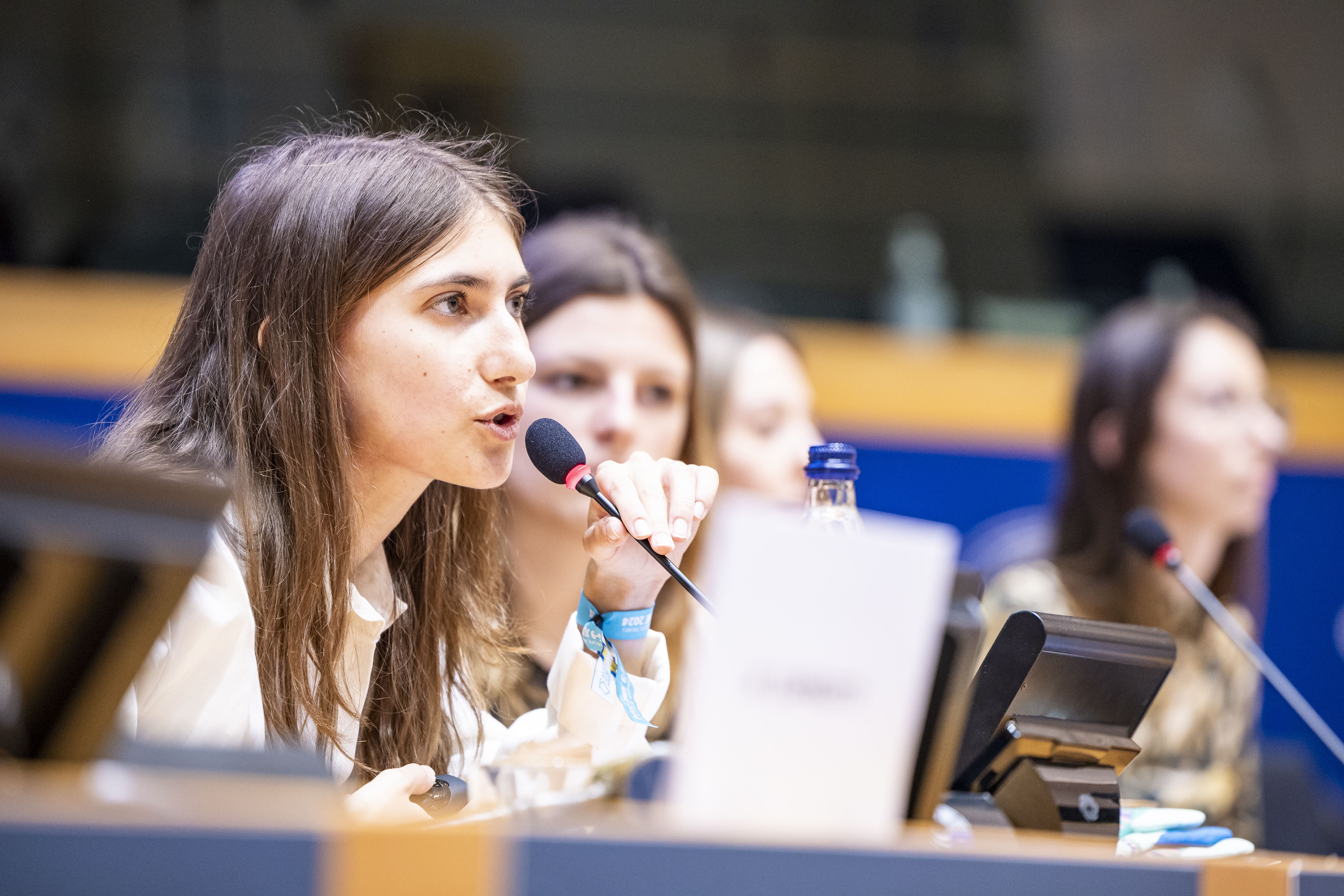 Young person speaking in the European Parliament in Brussels at the European Youth Week 2024.